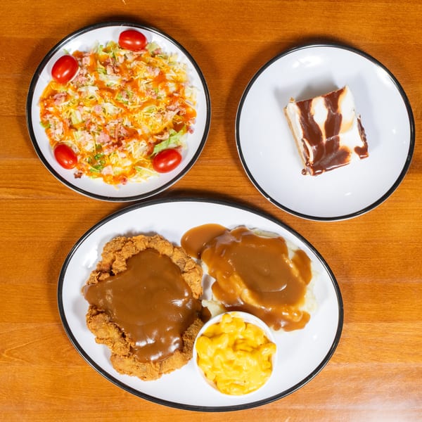Chicken fried steak with gravy, mashed potatoes, mac and cheese, a salad, and chocolate dessert.
