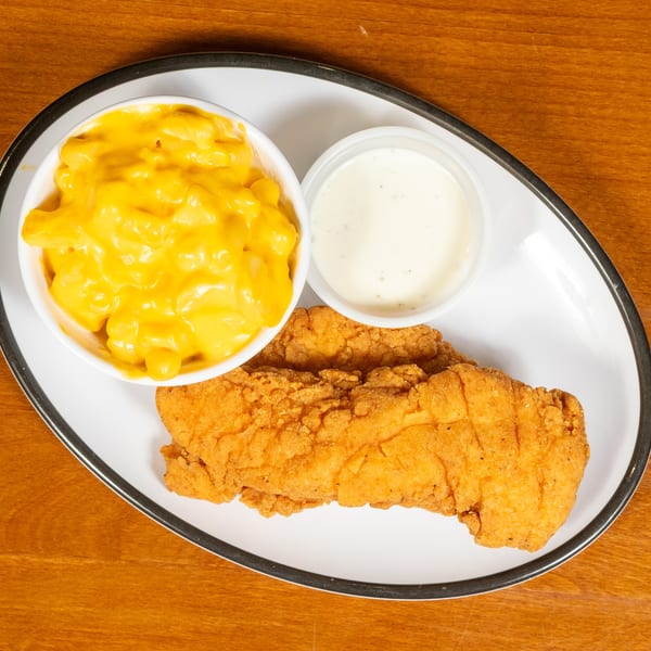 Fried chicken tenders, a side of mac and cheese, and a cup of ranch dressing on a white plate.